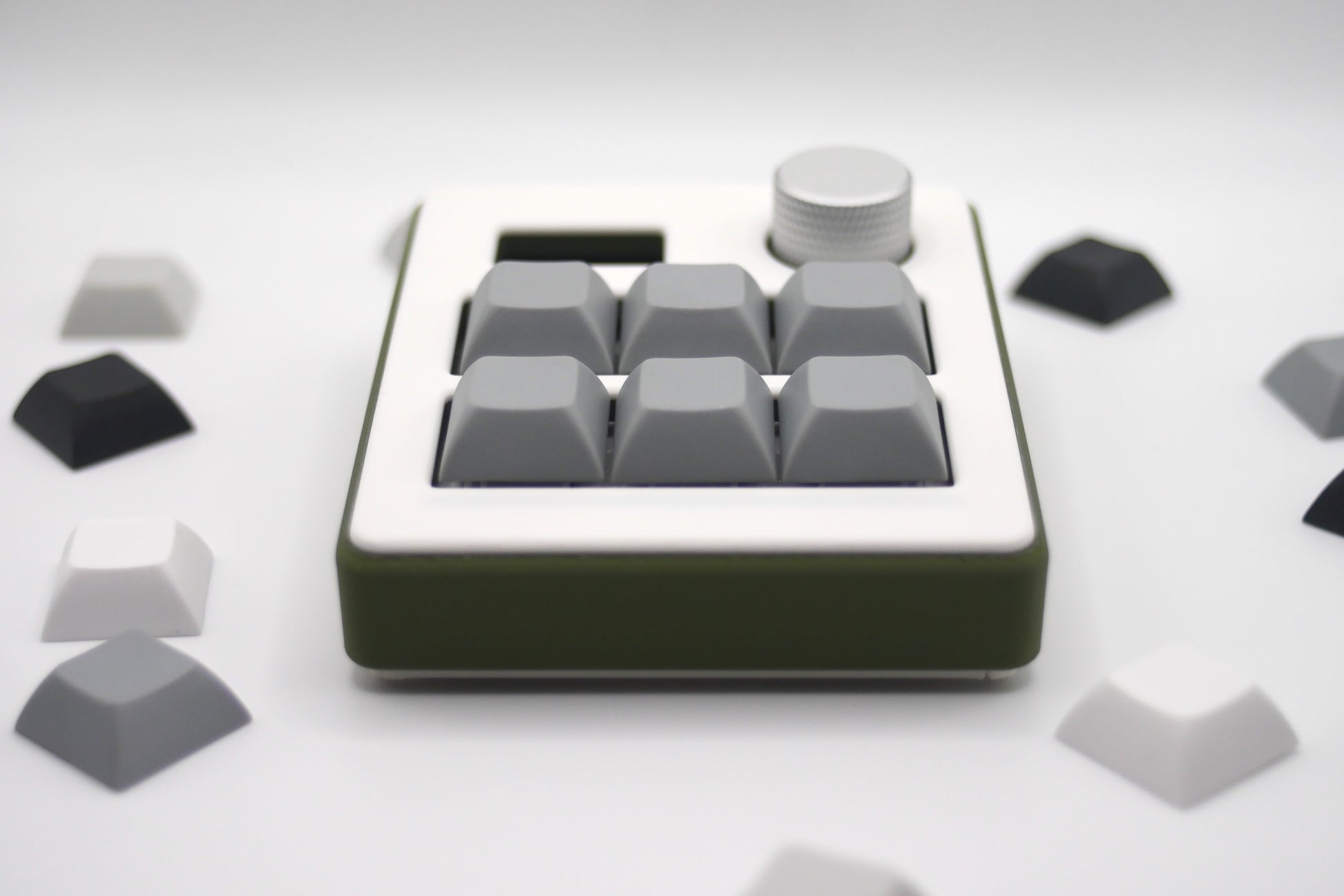 Close-up of TogKey Pad Plus top: hot-swappable switches and stealth RGB strip with knob and screen