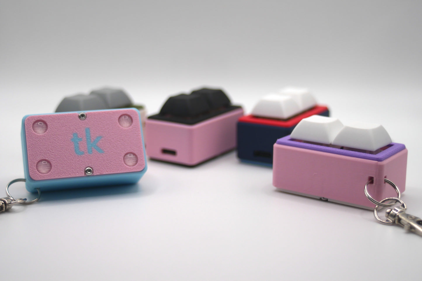 4 TogKey Pad Pocket Compact Customizable macropads in multiple colorways including pastel and dark colors and showing the bottom covers