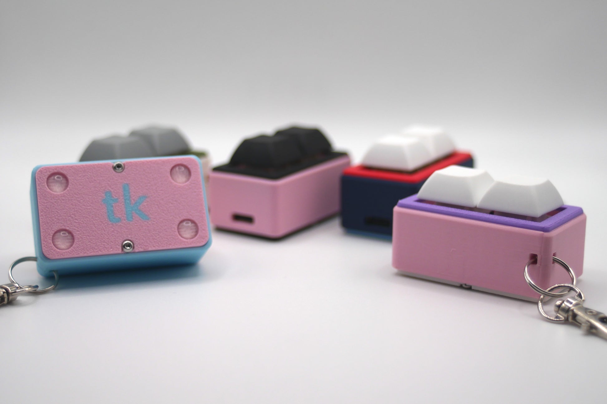 4 TogKey Pad Pocket Compact Customizable macropads in multiple colorways including pastel and dark colors and showing the bottom covers