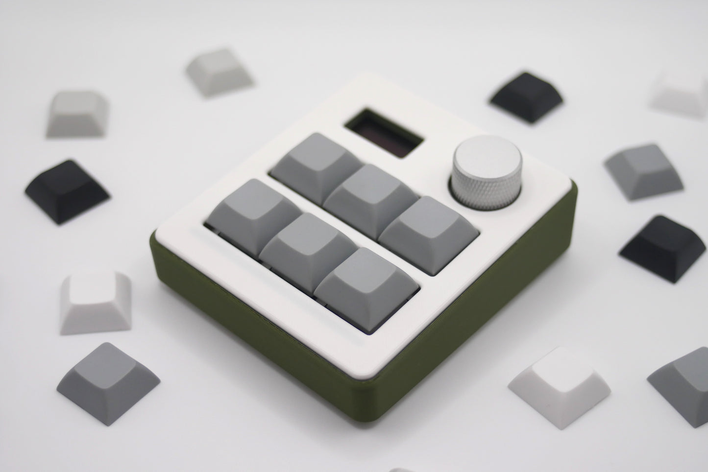 Close-up of TogKey Pad Plus top: hot-swappable switches and stealth RGB strip with knob and screen