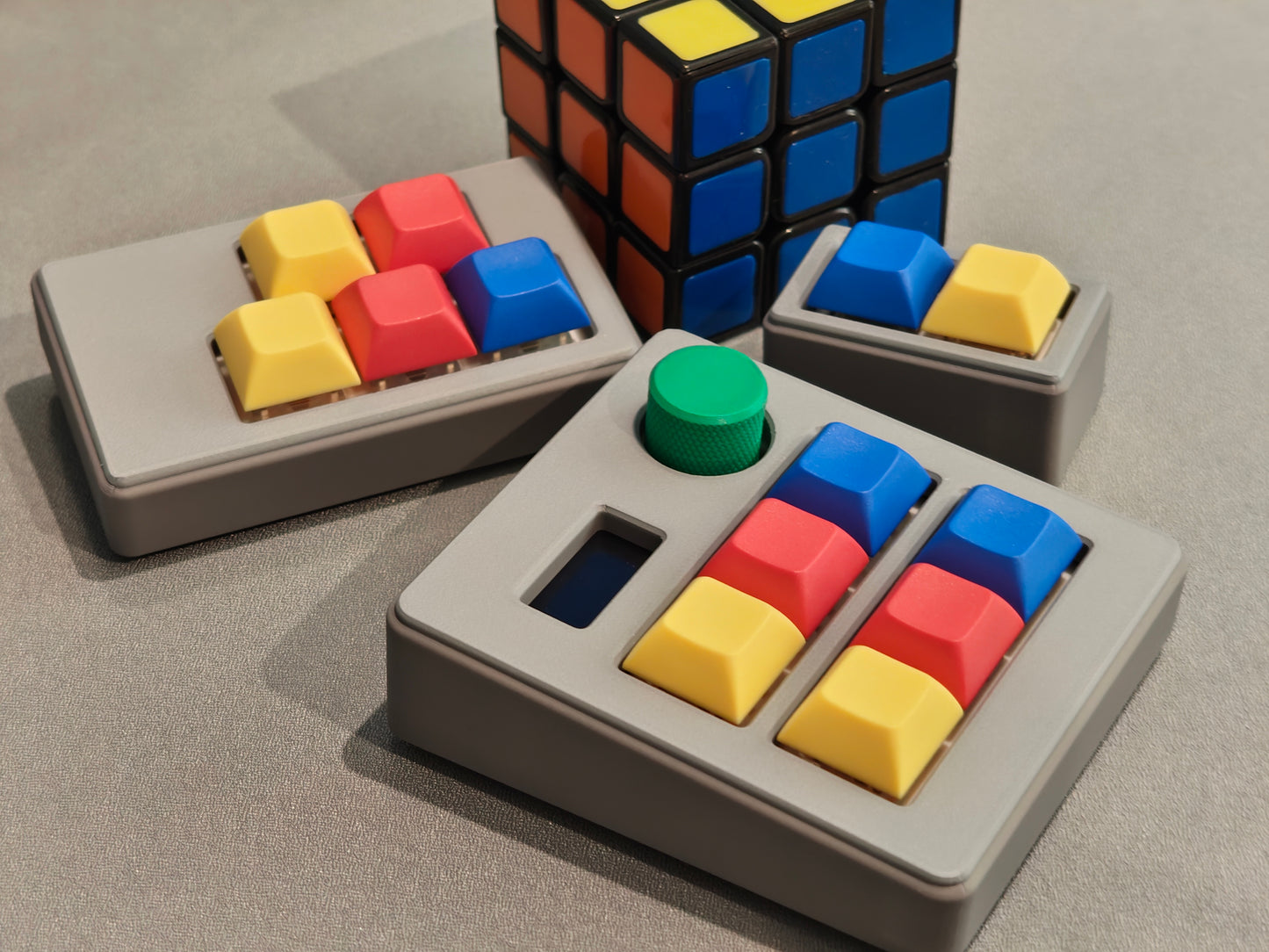 Colorful keycaps on a gray base with a Rubik's Cube in the background