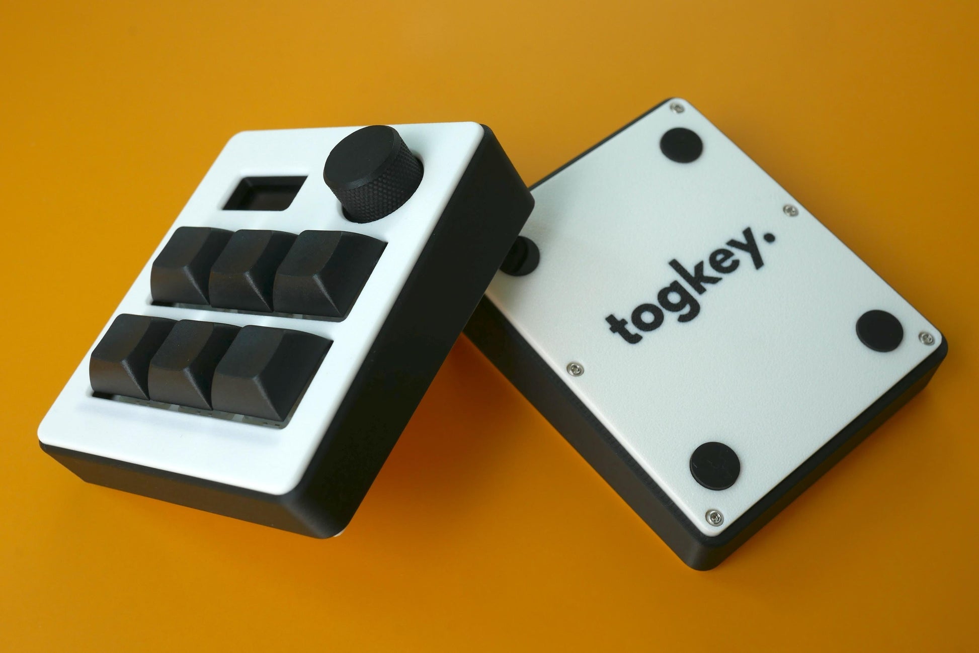 Togkey programmable macropad front and bottom view showing black and white 3d-printed case rubber feet and encoder knob