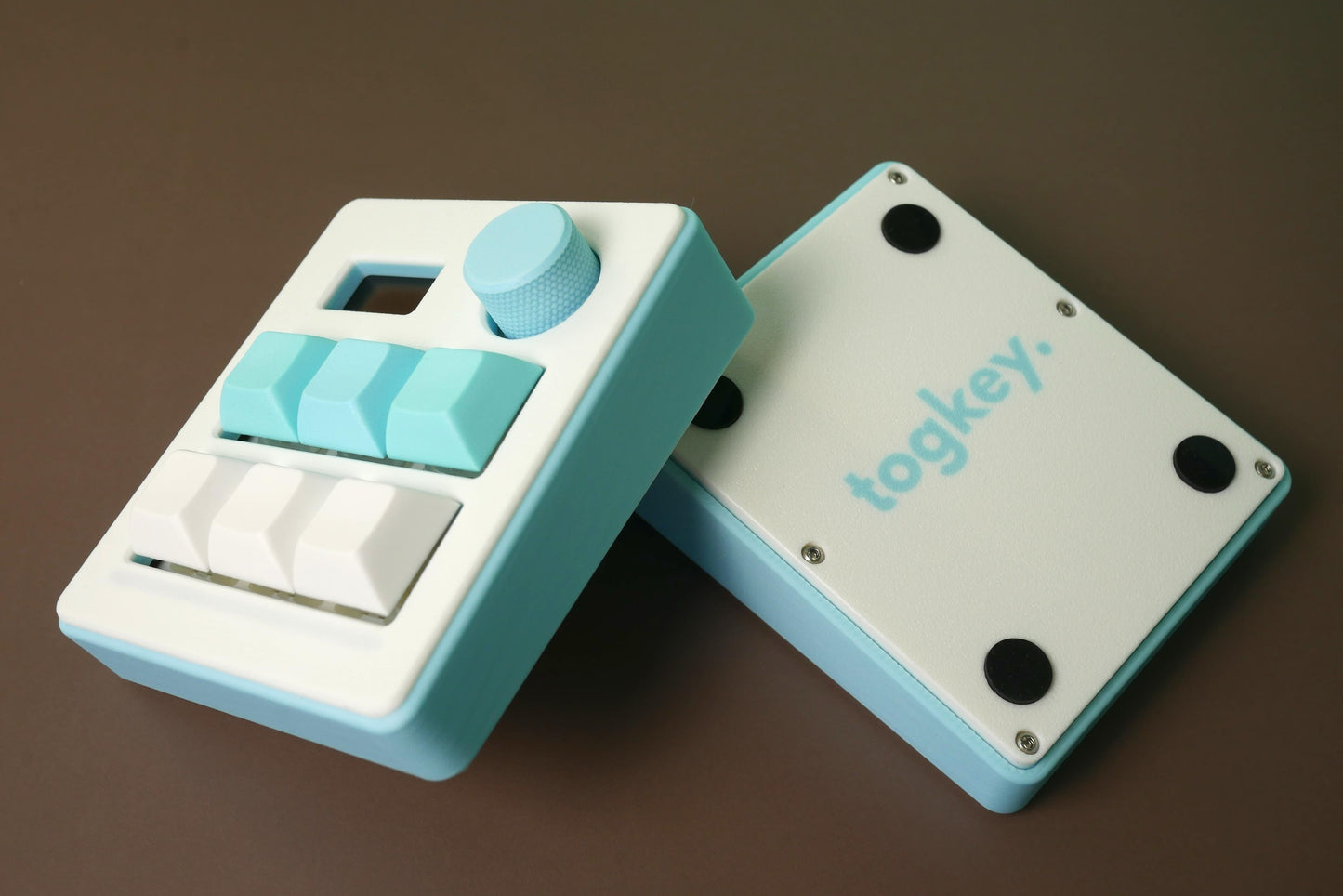 Togkey programmable macropad front and bottom view showing white and light blue 3d-printed case rubber feet and encoder knob