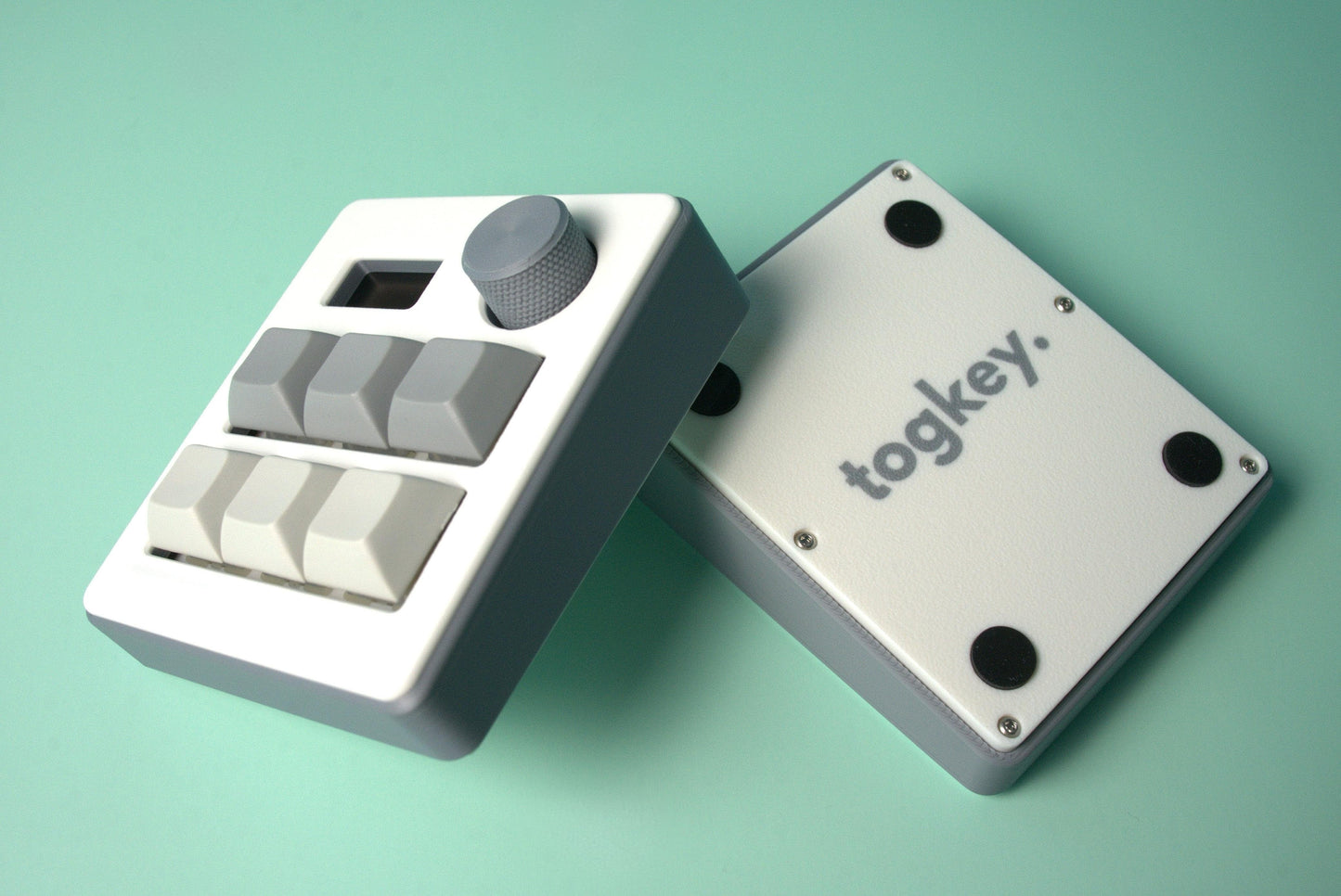 Togkey programmable macropad front and bottom view showing white and gray 3d-printed case rubber feet and encoder knob
