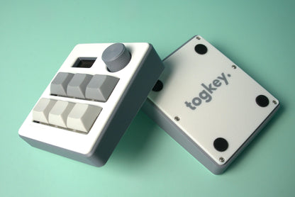 Togkey programmable macropad front and bottom view showing white and gray 3d-printed case rubber feet and encoder knob