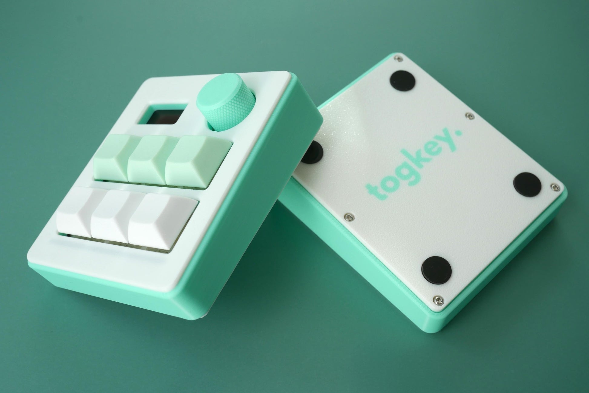 Togkey programmable macropad front and bottom view showing white and mint green 3d-printed case rubber feet and encoder knob
