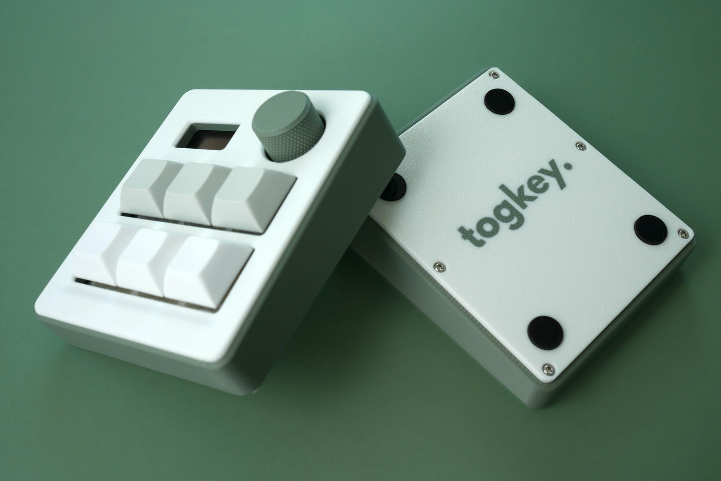 Togkey programmable macropad front and bottom view showing white and sage green 3d-printed case rubber feet and encoder knob