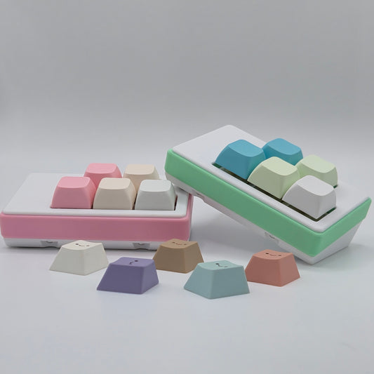 Two 5-Key customizable macropads in pink and mint green created by TogKey