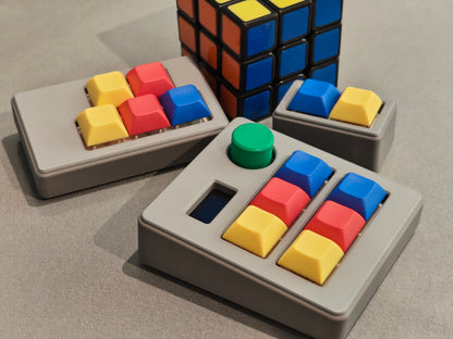 Colorful keycaps on a gray base with a Rubik's Cube in the background